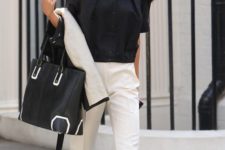 18 white trousers with a black top and bag