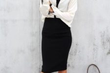 19 a black shirt, a black and white blouse and black and gold ankle shoes