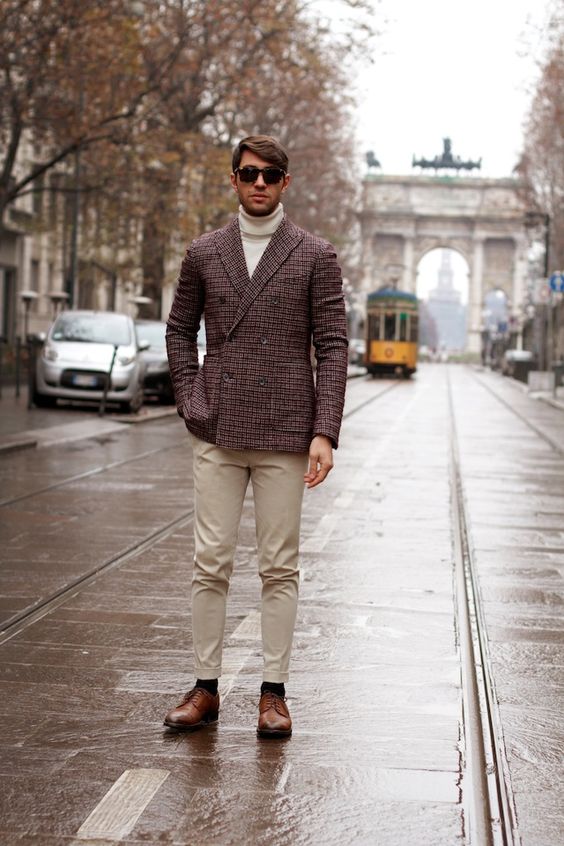 beige pants, a white turtleneck, a tweed jacket and cognac boots