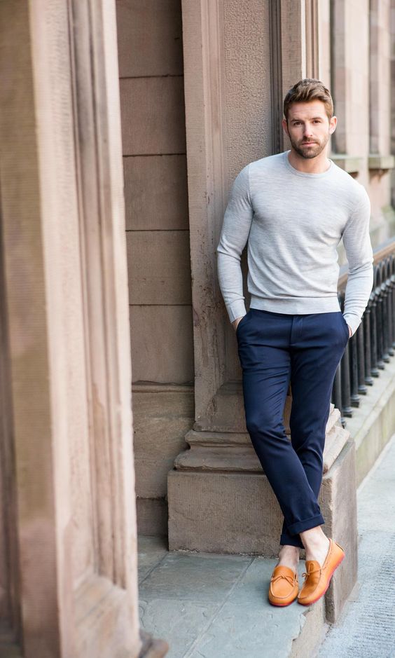 navy trousers, a light grey long sleeve and amber loafers