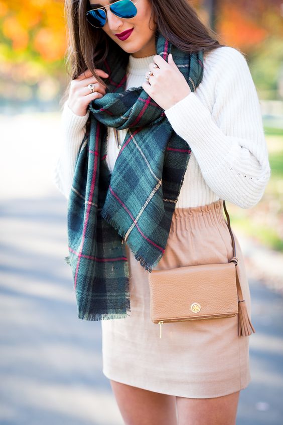 a plaid blanket scarf, a chunky knit sweater and a blush mini skirt