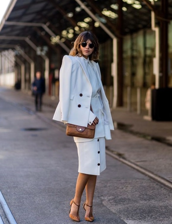 all-white look with a button down skirt and tan heels and bag