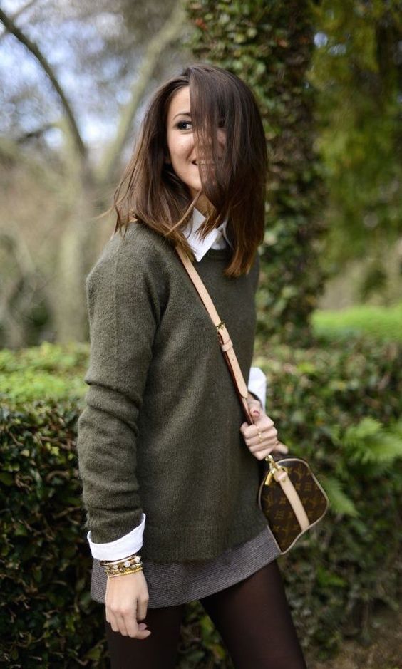 green sweater, a white button down, a mini tweed skirt