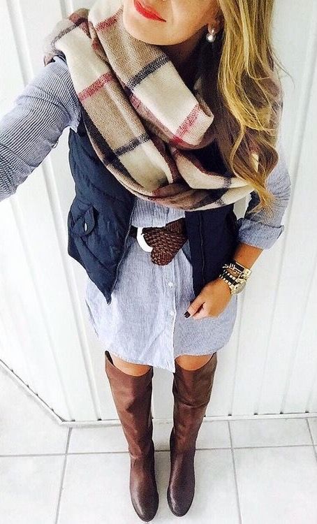 chambray button up dress, brown riding boots, navy vest, brown belt, and blanket scarf