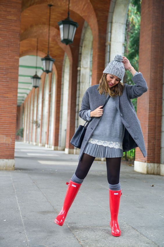 grey pleated dress, a grey coat, leg warmers