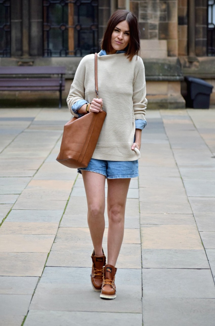 denim romper, a neutral oversized sweater and boots