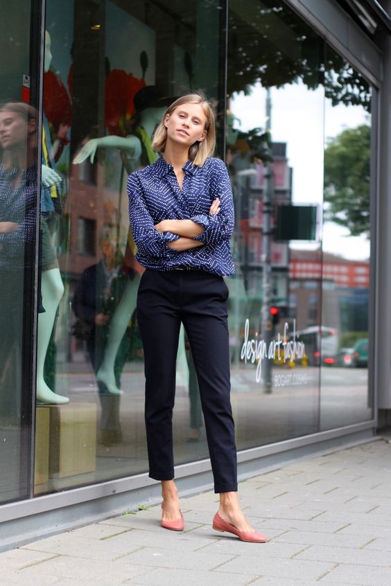 navy trousers, a dotted blue shirt and pink flats