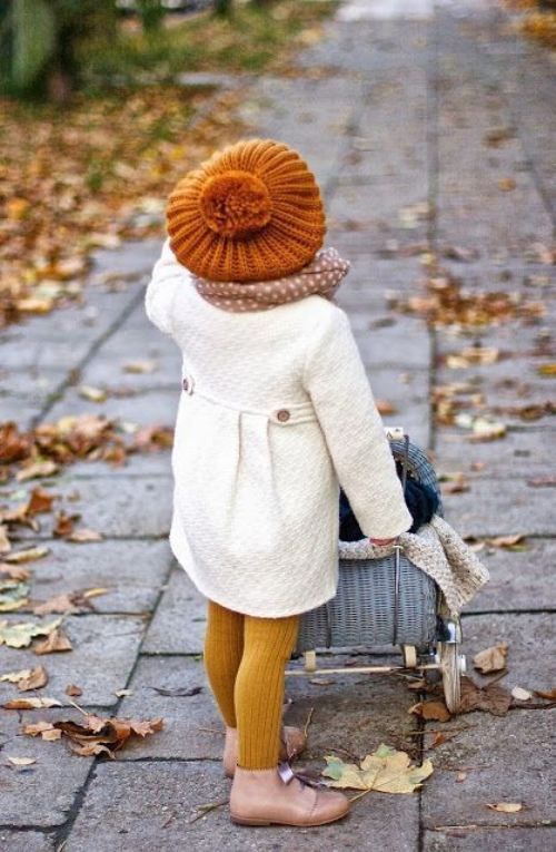 White coat, ocher leggings, blush boots, a polka dot scarf and an amber hat