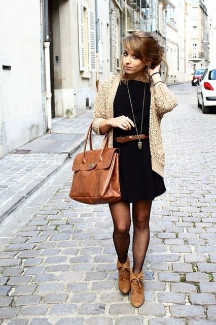 With black dress, neutral jacket and leather bag