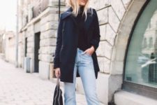 With black shirt, cuffed jeans and black ankle boots