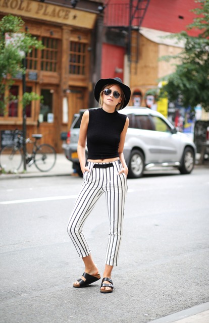 With black top, black hat and flat sandals