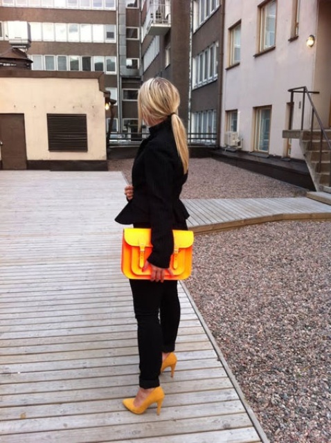With black trousers and yellow bag and shoes