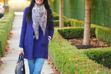 With coat, jeans and oversized scarf