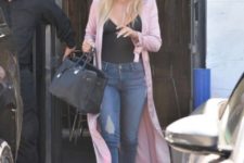 With cropped jeans, boots and big bag