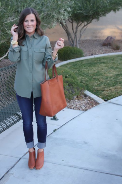 With green army shirt, cuffed jeans and tote bag