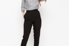 With high-waisted black trousers and black shoes