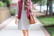With loose striped dress, ankle boots and leather bag