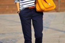 With loose striped shirt, black flats and orange bag