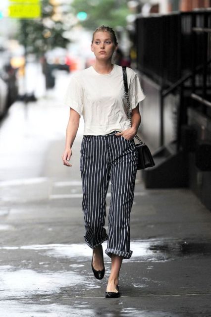 With loose white t-shirt and black flats