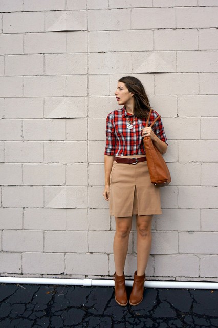 With plaid shirt, beige skirt and leather bag