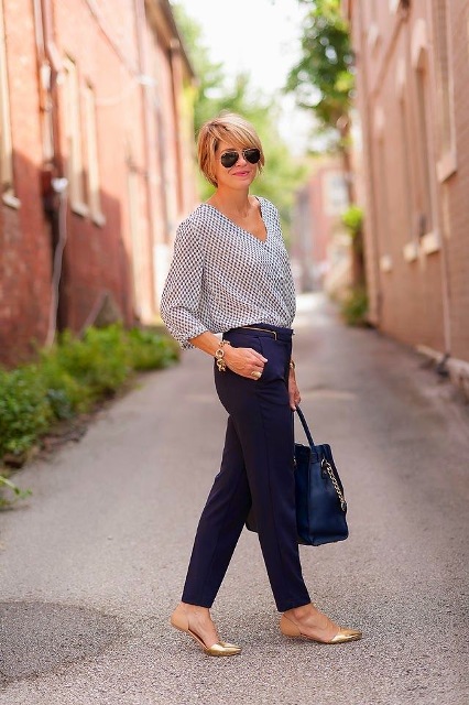With printed shirt, golden flats and dark blue bag