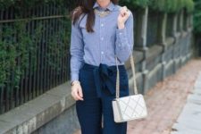 With striped shirt, white bag and statement necklace