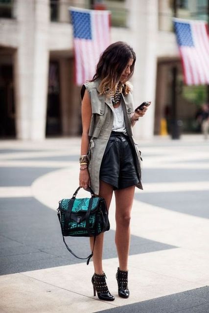 With white blouse, leather shorts and boots