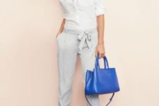 With white classic shirt, gray shoes and bright blue bag