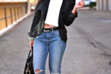 With white crop top, cuffed jeans and heels