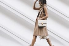 With white dress, beige long vest and white bag