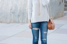 With white pullover, distressed jeans and mini bag