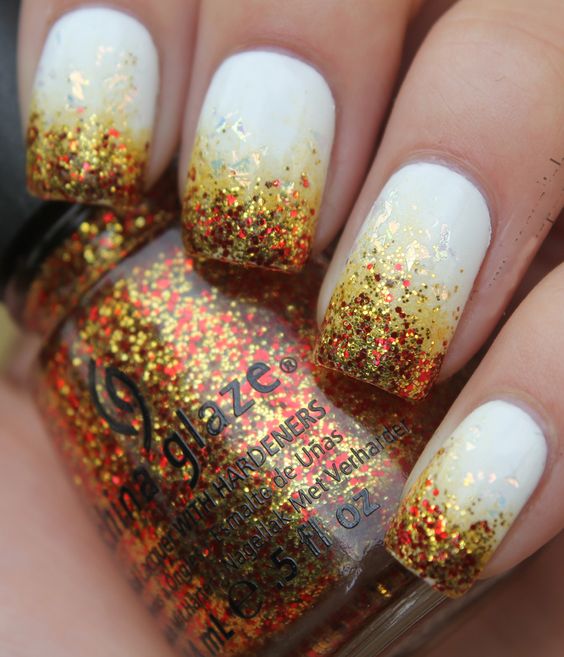 white nails with gradient glitter in fall shades