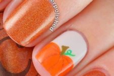 07 glitter orange nails with a pumpkin accent
