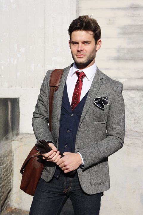 black jeans, a tweed jacket, a navy cardigan and a shirt with a tie