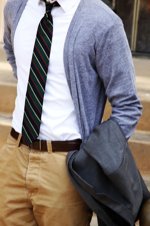 dusty blue cardigan, a striped tie and tan pants