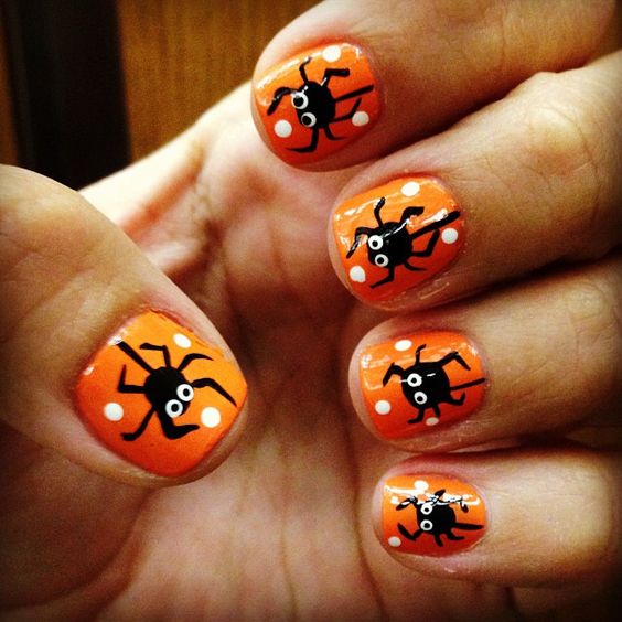 bold orange nails with fun spider decals