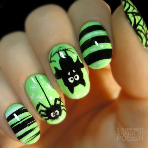 neon green nails with black accents, spiders and bats