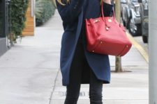 With black jeans, big red bag and embellished boots