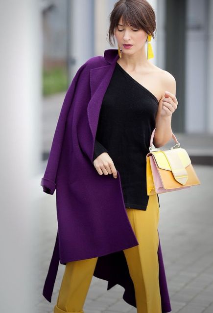 With black top, yellow trousers and small bag
