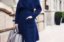 With blue midi coat and crop jeans