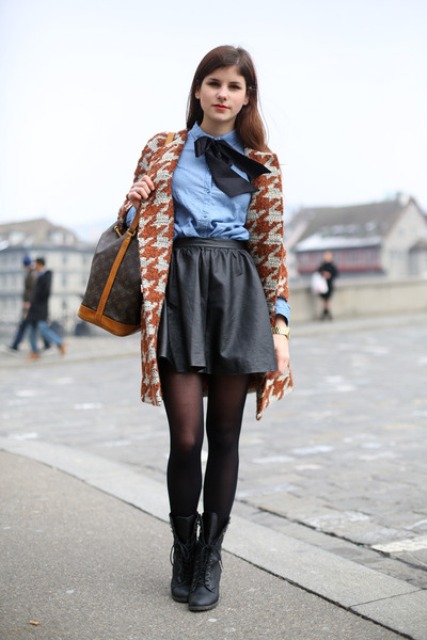 With blue shirt, leather skirt and printed jacket
