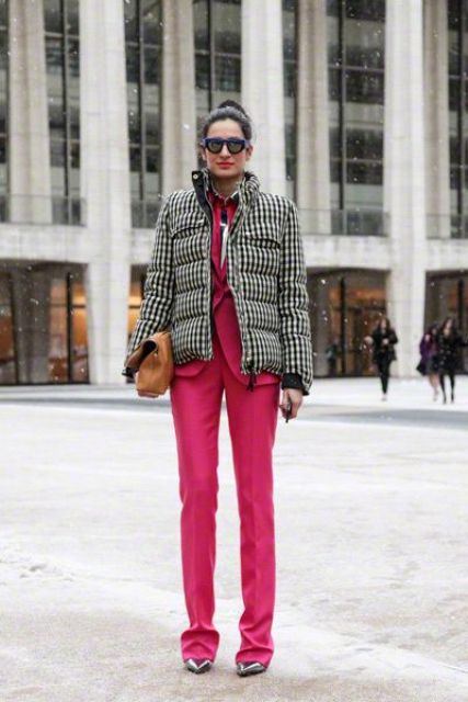 With bright pink suit, metallic shoes and leather clutch