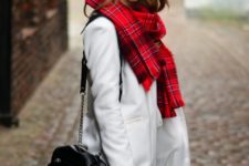 With bright plaid scarf and chain strap bag