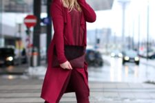 With burgundy coat, hat and heels
