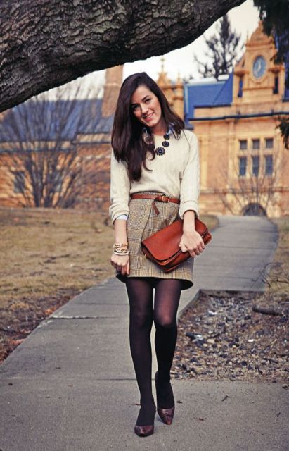 With creme sweater, leather belt and clutch