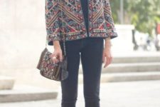 With cuffed skinny jeans, ankle boots and embroidered bag