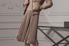 With light brown shirt, pleated skirt and ankle boots