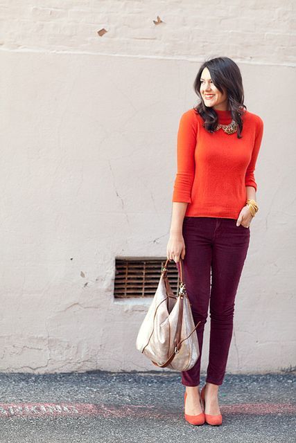 With orange shirt, statement necklace and tote