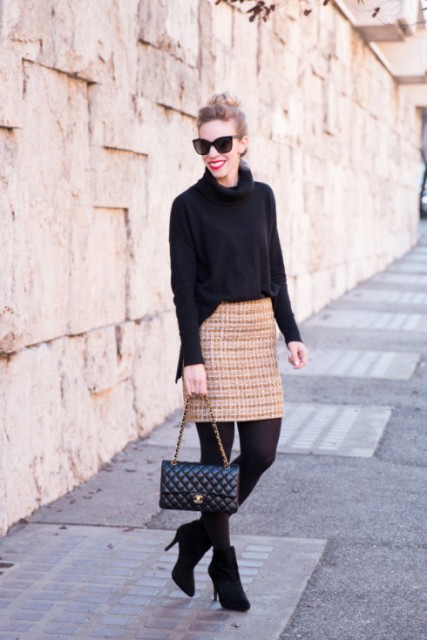 With oversized black sweater, black tights and ankle boots