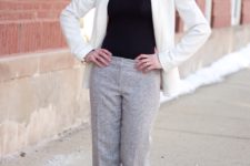 With turtleneck, statement necklace and white jacket